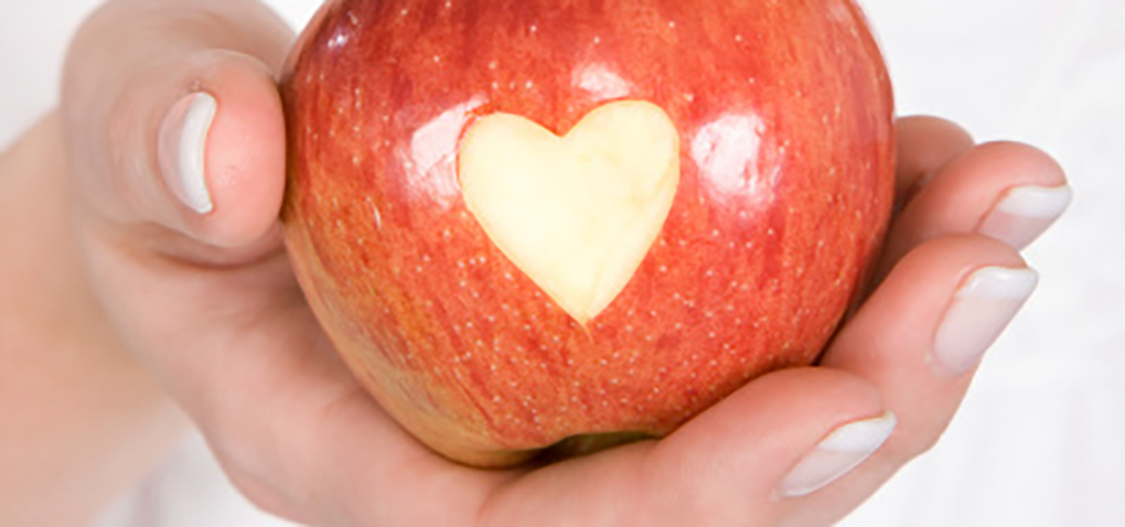 an apple with a carved heart