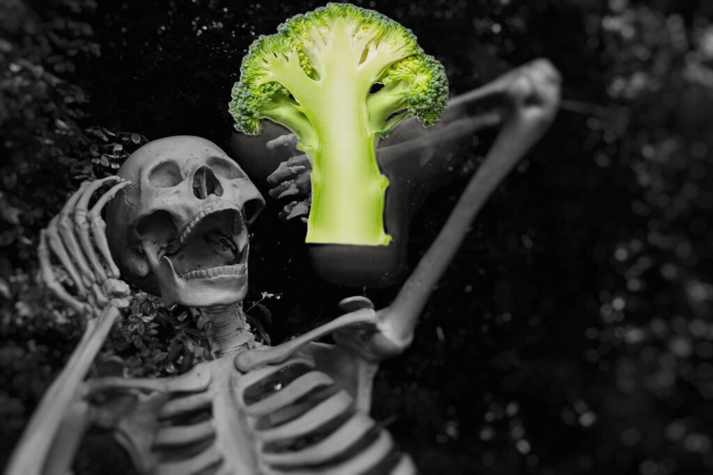 skeleton screaming and looking at a piece of broccoli