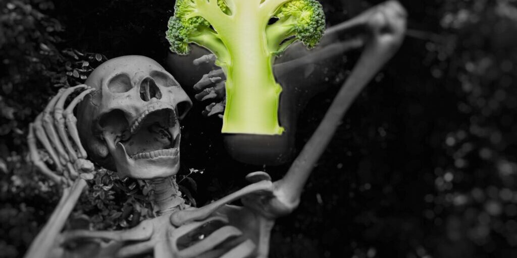 skeleton screaming and looking at a piece of broccoli